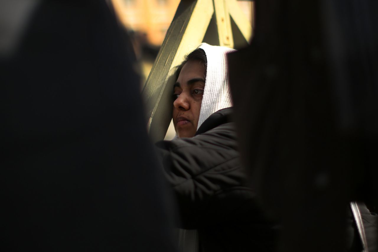A woman prays during the inauguration Mass.