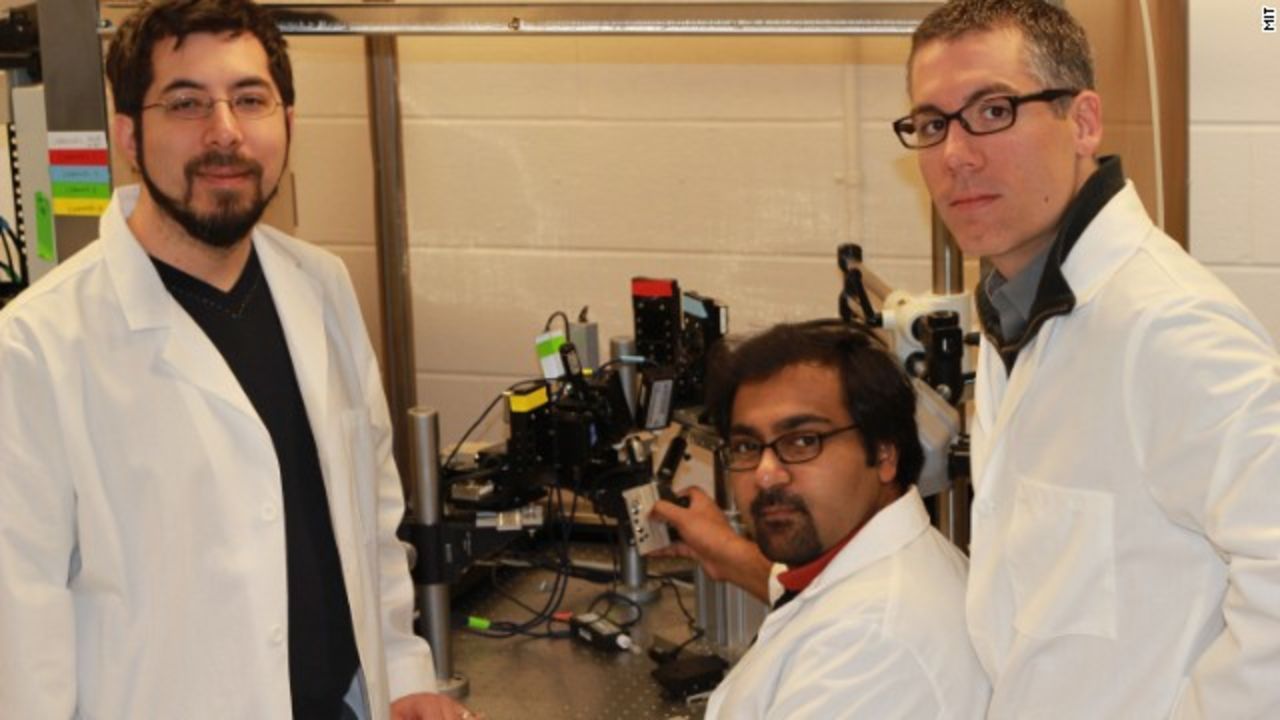 MIT researcher Ed Boyden (left), and Georgia Tech researchers Suhasa Kodandaramaiah (seated) and Craig Forest collaborated on a robotic system.