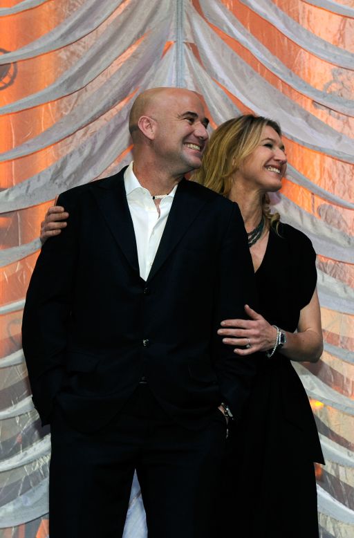 Pro tennis players Andre Agassi and Steffi Graf have 30 grand slam singles titles between them, and they still play together in doubles exhibition matches. They married in 2001. Pictured, the couple smiles from onstage during a nonprofit event, February 2012.