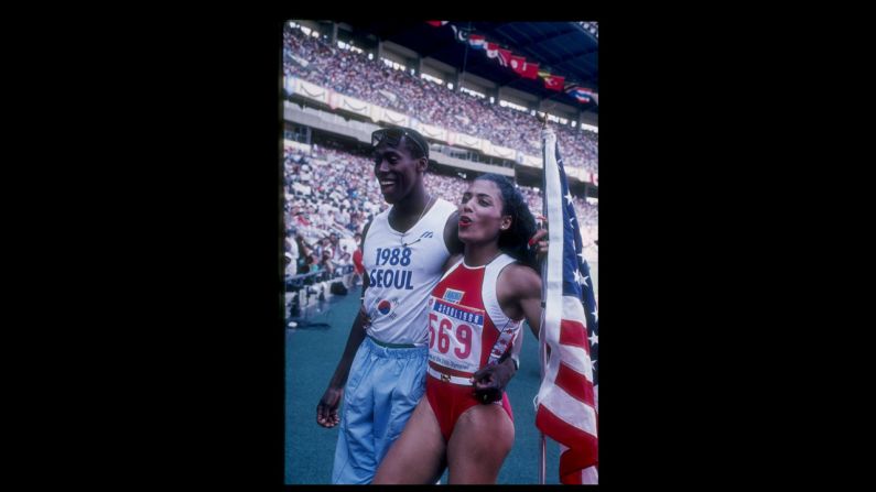 Florence Griffith-Joyner, known as Flo Jo, and Al Joyner, Olympic gold medal winning triple jumper and Flo Jo's coach, met at the U.S. Olympic trial in 1980 and married in 1987. Flo Jo won golds in both the 100 meter and 200 meter at the Seoul Olympics in the following year. She died in 1998. Pictured, she walks off the track with her husband Al Joyner during the Olympic Games in Seoul, South Korea, 1988.