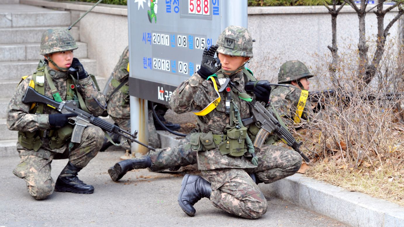 South Korean soldiers take part in a drill to guard the building of a state-run telecom company in Seoul against potential guerrilla attacks on Thursday, March 14.