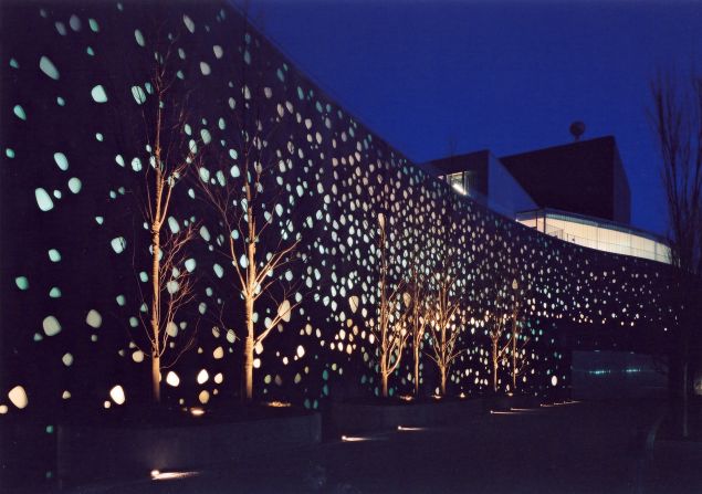Designed by Pritzker Prize-winning architect Toyo Ito, the Matsumoto Performing Arts Centre features a perforated facade that at night appears illuminated.