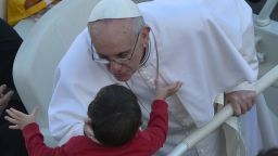 Pope Francis blesses a child as he arrives in the papamobile on St Peter's square for his grandiose inauguration mass on March 19, 2013 at the Vatican. 