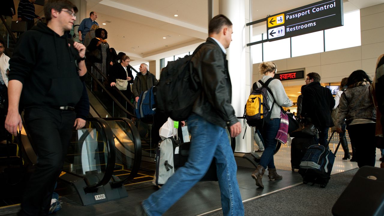 Arriving international air travelers head to Passport Control at Dulles International Airport.