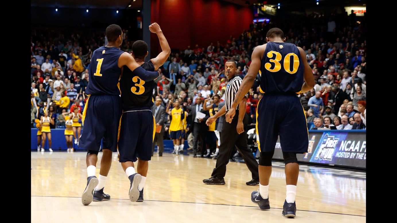 From left: Adrian Powell, Jeremy Underwood and Lamont Middleton of the North Carolina A&T Aggies celebrate after beating the Liberty Flames 73-72 during their First Four round on March 19 in Dayton. The Aggies will face No. 1 seeded Louisville on March 21.