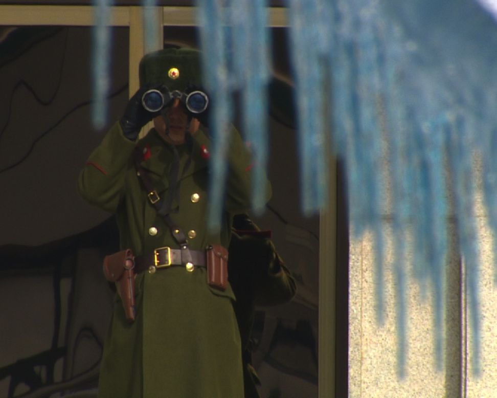 One North Korean soldier observes us closely with his binoculars through the icicles.