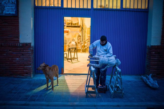 Daniel Guitarte , 22, works on a ninot, or large puppet, outside his Valencia workshop on February 11 in preparation of the festival.