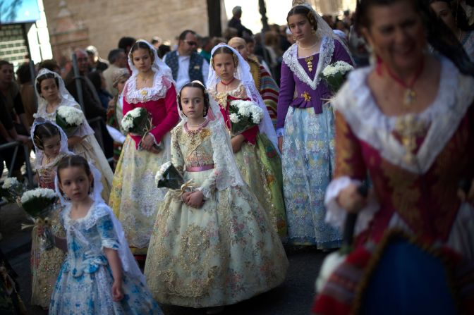 Girls dressed up in traditonal costume prepare to present flowers to St. Mary on March 18.