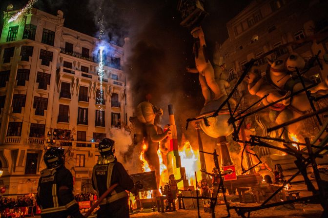 Firefighters put out a falla on the festival's final day, March 20.
