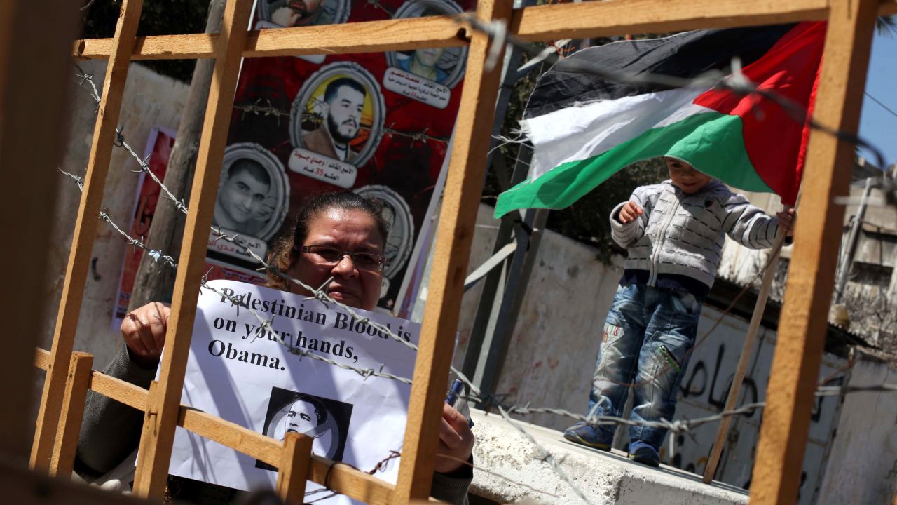 Palestinians in Gaza City hold up placards demonstrating against Obama's visit on March 20.
