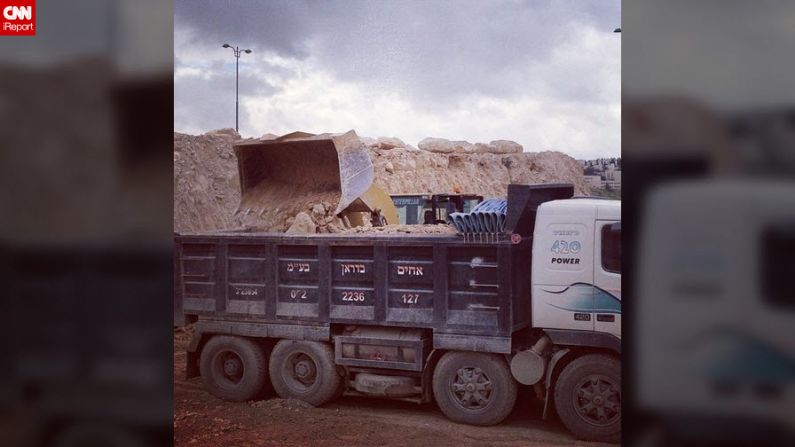 Israeli workers clear the site of a controversial new subdivision at the Israeli settlement of Ma'ale Adumim in the West Bank. 