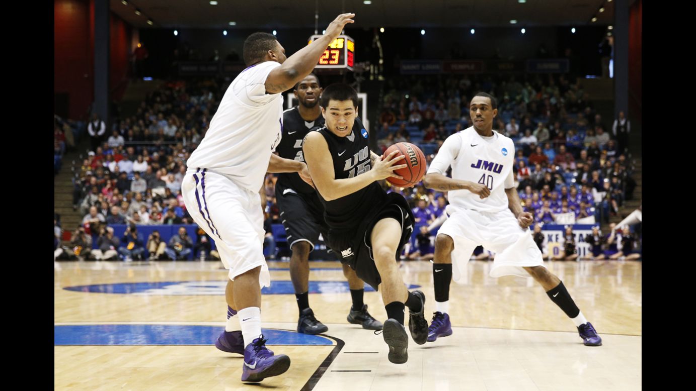 Jason Brickman of the LIU Brooklyn Blackbirds drives against Rayshawn Goins of the James Madison Dukes during the First Four round of the NCAA tournament on March 20, in Dayton. James Madison defeated LIU Brooklyn 68-55. 