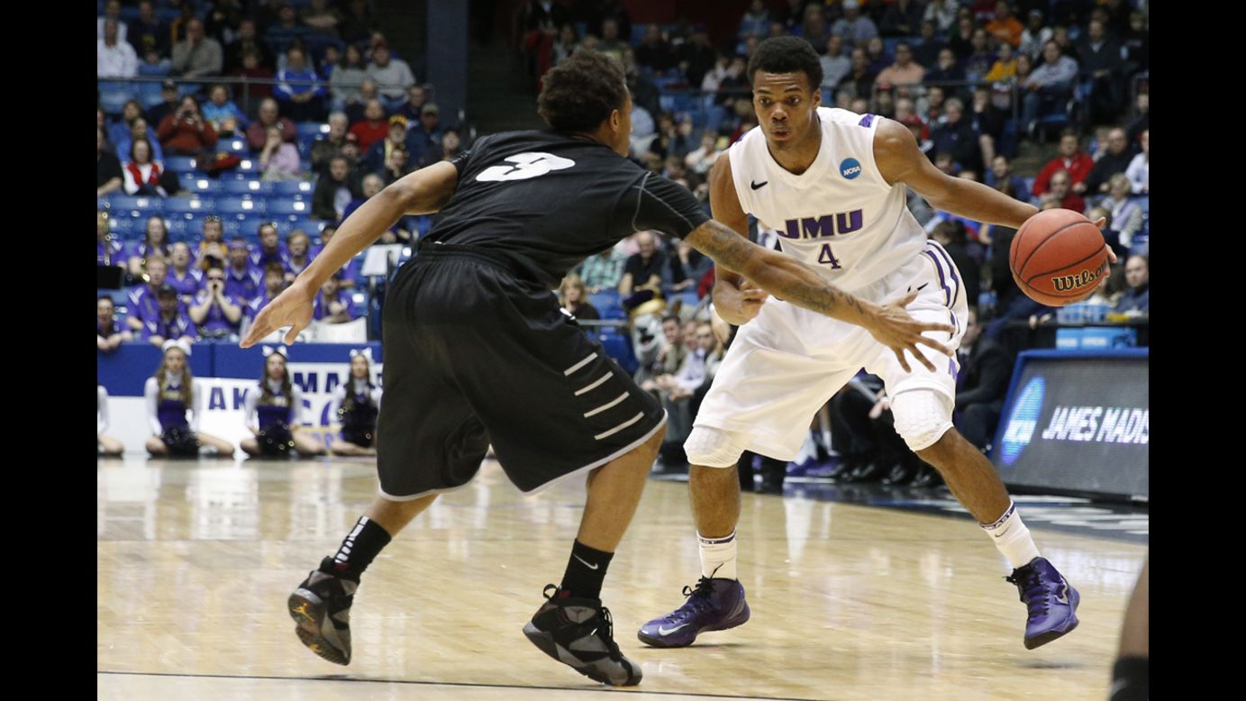 Charles Cooke of the James Madison Dukes drives against C.J. Garner of LIU Brooklyn during the first half on March 20.