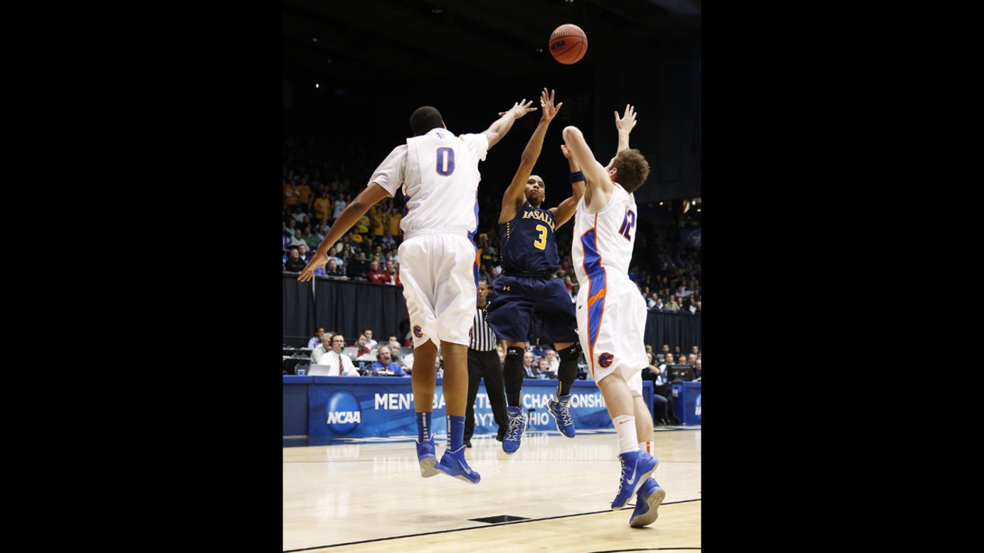 Tyreek Duren of the La Salle Explorers takes a shot as Ryan Watkins, left, and Igor Hadziomerovic, right, of the Boise State Broncos defend on March 20.