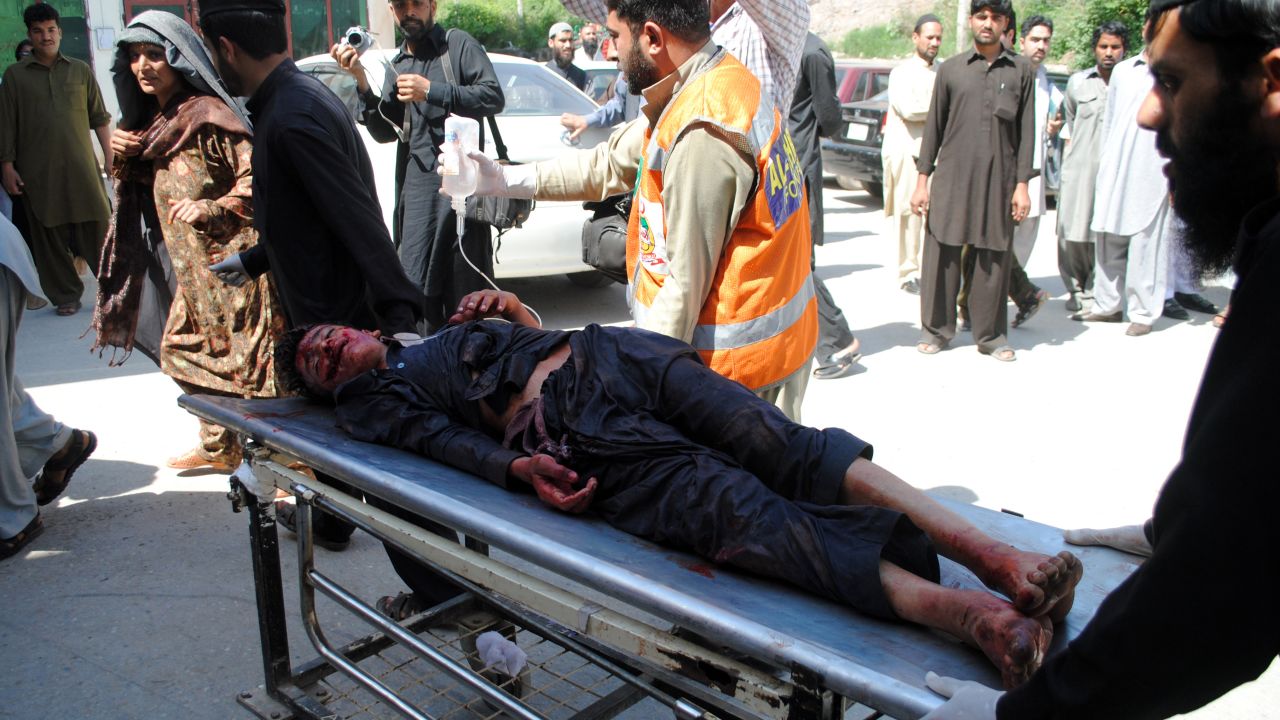 A blast victim is taken to a hospital following a car bomb blast at a refugee camp in Pakistan on Thursday.
