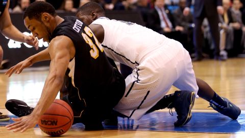 Tekele Cotton of Wichita State, left, tries to recover the ball as Tray Woodall of Pittsburgh goes after it on March 21.