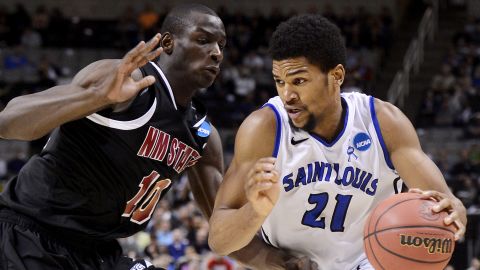 Dwayne Evans of the St. Louis Billikens drives against Bandja Sy of the New Mexico State Aggies on March 21 in San Jose, California. 