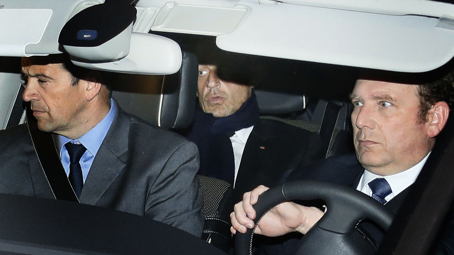 Former French president Nicolas Sarkozy (C) leaves Bordeaux' courthouse on March 21, 2013.