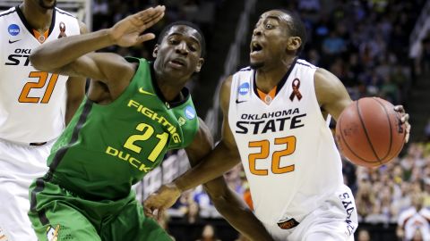 Markel Brown of Oklahoma State drives against Damyean Dotson of Oregon on March 21.