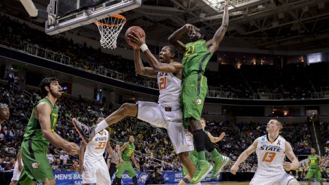 Kamari Murphy of the Oklahoma State Cowboys shoots after grabbing the rebound against Damyean Dotson of the Oregon Ducks on March 21 in San Jose, California. 