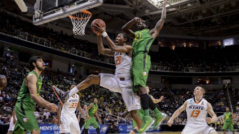 Kamari Murphy of the Oklahoma State Cowboys shoots after grabbing the rebound against Damyean Dotson of the Oregon Ducks on March 21 in San Jose, California.