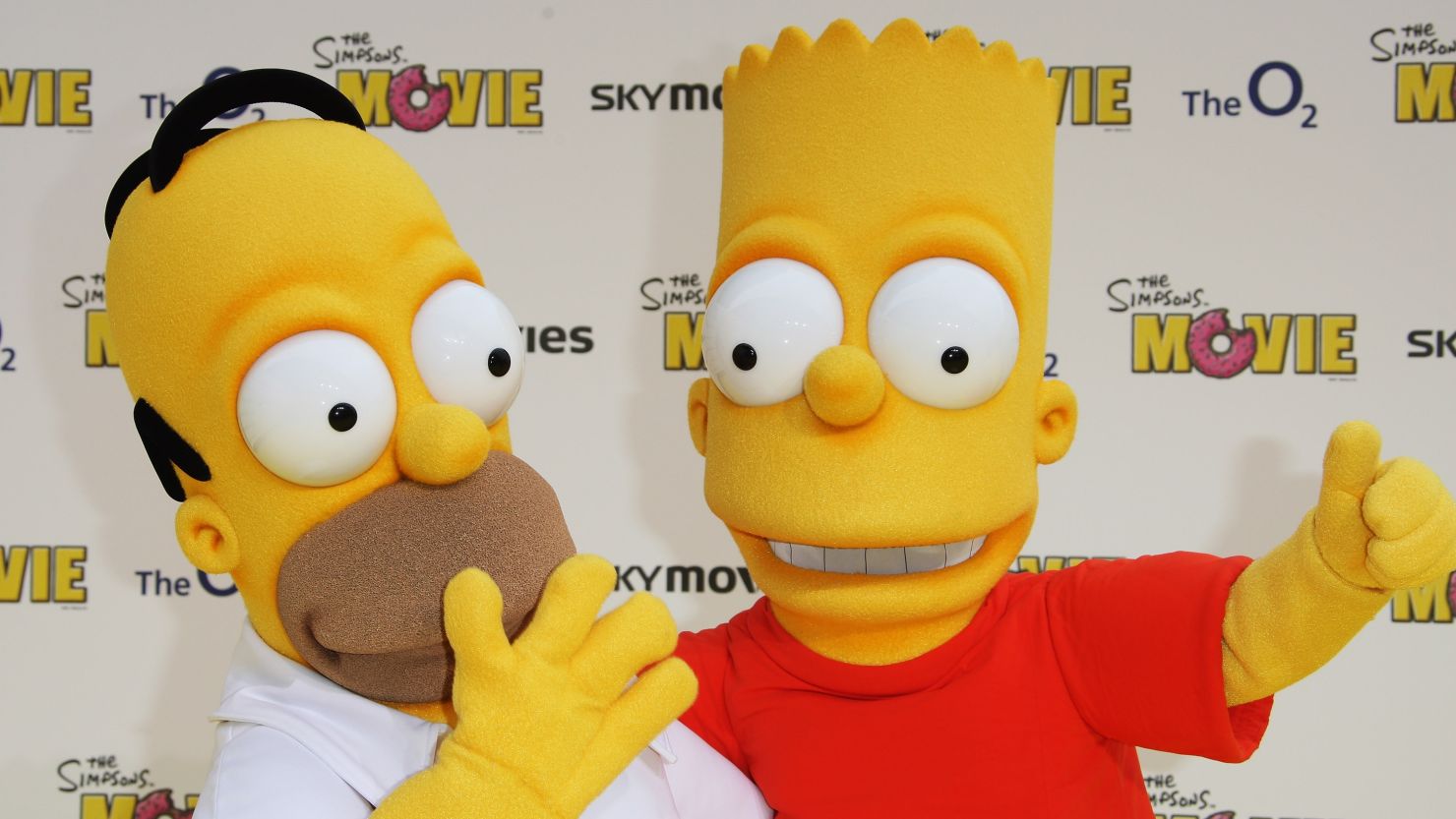 Characters Homer (L) and Bart Simpson (R) arrive at the Simpsons movie premiere in London, England on July 25, 2007.