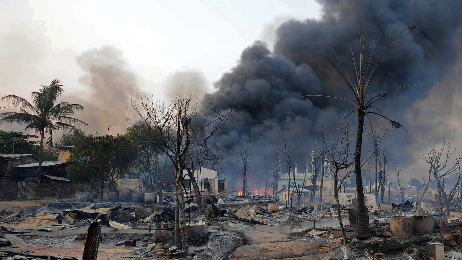Smoke rises from burning houses around a mosque in riot-hit Meiktila, central Myanmar on Thursday.