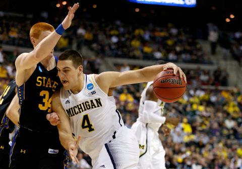 Mitch McGary of Michigan moves the ball against Tony Fiegen of South Dakota State on March 21.