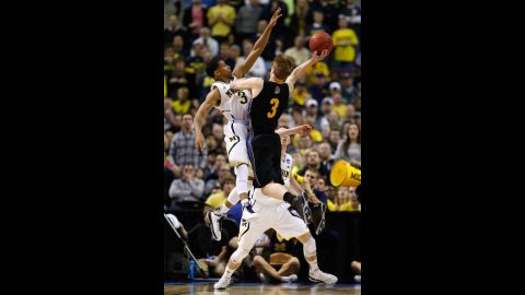 No. 3 Nate Wolters of the South Dakota State Jackrabbits drives for a shot attempt against No. 3 Trey Burke of the Michigan Wolverines on March 21.