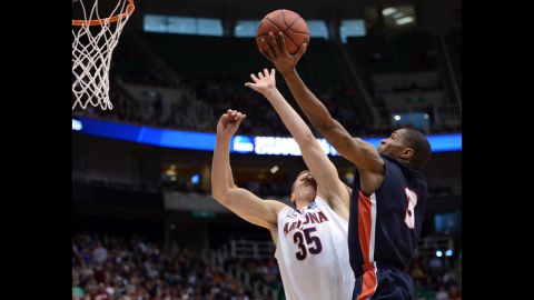 Kerron Johnson of the Belmont Bruins tries for a lay-up over Kaleb Tarczewski of the Arizona Wildcats on March 21 in Salt Lake City, Utah.