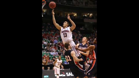 Nick Johnson of Arizona takes a shot as he jumps into Reece Chamberlain of Belmont on March 21.