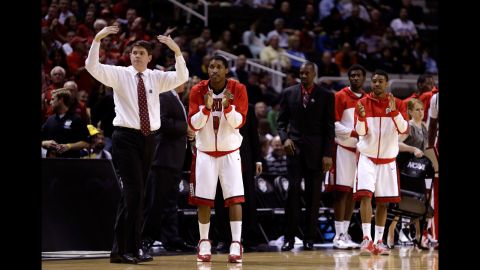 Head coach Dave Rice of the UNLV Rebels and his players react after a play against the California Golden Bears on March 21.