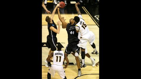 Zeke Marshall, center, and Brian Walsh, left, of Akron fight for a rebound against Juvonte Reddic of VCU on March 21.