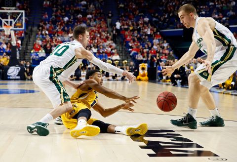 Phil Pressey of the Missouri Tigers tries to pass the ball away against Pierce Hornung and Wes Eikmeier of the Colorado State Rams on March 21 in Lexington, Kentucky. 