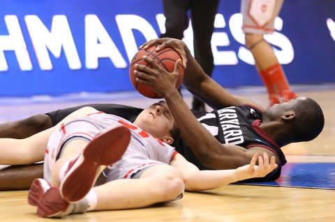 Cameron Bairstow of New Mexico and Steve Moundou-Missi of Harvard battle for a loose ball on March 21.