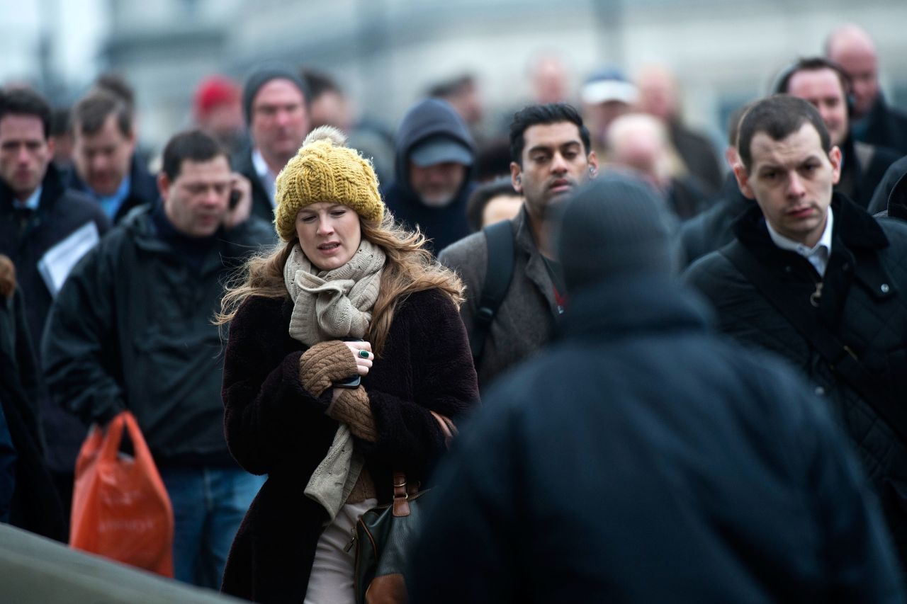 Cold weather keeps Britons bundled up as they cross the London Bridge on March 22. 