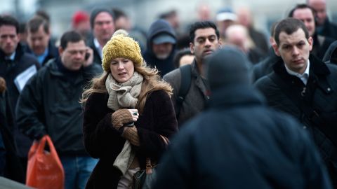 Cold weather keeps Britons bundled up as they cross the London Bridge on March 22.