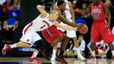 Ben Brust of the Wisconsin Badgers, left, steals the ball from Nick Williams, center, of the Ole Miss Rebels on March 22 in Kansas City, Missouri. 