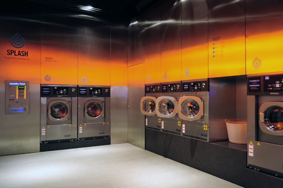 What do you get when you cross being fresh with even fresher?  A laundromat that looks like a club! Splash, a chain of self-service laundromats in Spain, are a far cry from your average dingy neighborhood washhouse. <a href="http://www.fredericperers.cat/" target="_blank" target="_blank">According to designer Frederic Perers</a>, the eco-friendly cleaning center features steel surfaces that reflect orange tones on the opposite wall, serving as a "warm counterelement to the coldness of the metal." But will a club-like atmosphere really attract a younger clientele?