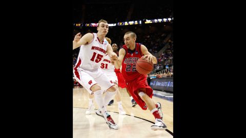 Marshall Henderson of the Ole Miss Rebels, right, drives against Sam Dekker of the Wisconsin Badgers on March 22.