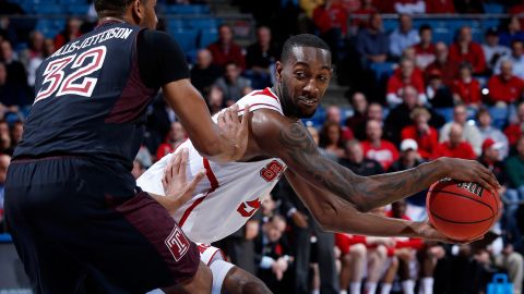 C.J. Leslie of the North Carolina State Wolfpack, right, looks to pass against Rahlir Hollis-Jefferson of the Temple Owls on March 22.