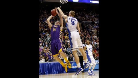 Sam Rowley of the Albany Great Danes, left, shoots over Mason Plumlee of the Duke Blue Devils on March 22.