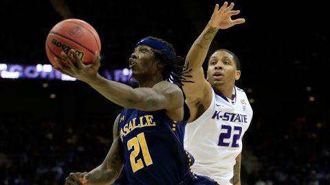 Tyrone Garland of the La Salle Explorers, left, shoots against Rodney McGruder of the Kansas State Wildcats on March 22 in Kansas City, Missouri.