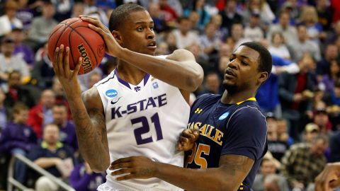 Jordan Henriquez of the Kansas State Wildcats, left, looks to pass against Jerrell Wright of the La Salle Explorers on March 22.