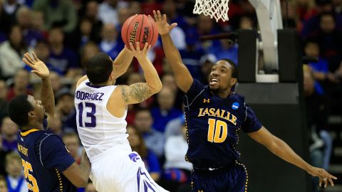 Angel Rodriguez of the Kansas State Wildcats, second from left, shoots against Jerrell Wright, left, and Sam Mills of the La Salle Explorers on March 22.