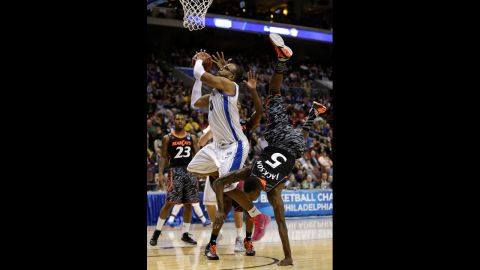 Justin Jackson of the Cincinnati Bearcats, right, fouls Gregory Echenique of the Creighton Bluejays on March 22.