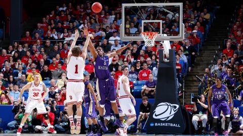 Jordan Hulls of the Indiana Hoosiers, second from left, shoots a three-point basket against Alioune Diouf, third from left, of the James Madison Dukes on March 22.