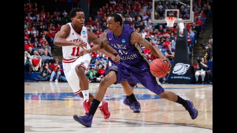 Devon Moore of the James Madison Dukes, right, dribbles the ball against Kevin "Yogi" Ferrell of the Indiana Hoosiers on March 22.