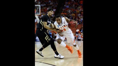 Tracy Abrams of the Illinois Fighting Illini, right, drives past Askia Booker of the Colorado Buffaloes on March 22.