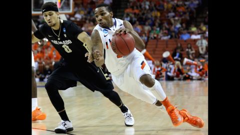 Tracy Abrams of the Illinois Fighting Illini, right, drives past Askia Booker of the Colorado Buffaloes on March 22.